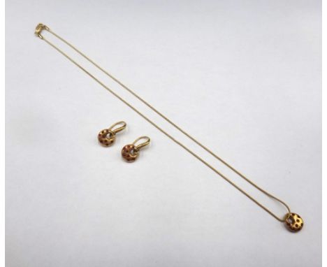 A pair of 18ct gold and ruby earrings, each with a circular front, set with circular cut rubies, suspended from a twisted wir