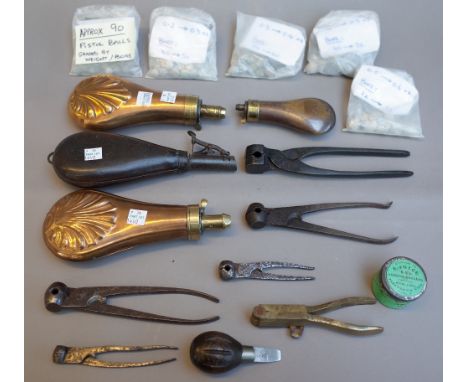 A collection of firearm accoutrements, including; pistol balls and bullets, four powder flasks, eight ball moulds and tools, 