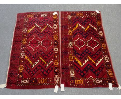A pair of Ersari Chuvals, the madder fields with two cross medallions, zig-zag supporting bands; a square and bracket border,
