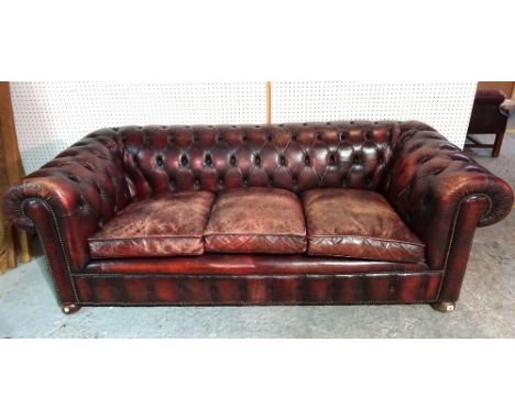 A 20th century mahogany framed Chesterfield sofa with red leatherette button back upholstery, 210cm wide.  L4