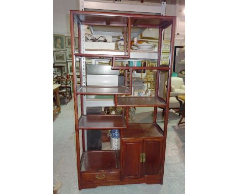 An early 20th century Chinese multi-tier shelf with single drawer and cupboard, 91cm wide x 173cm high x 38cm deep.   BAY 2