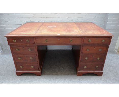 A mid-18th century style mahogany partner's desk, with nine drawers about the knee and opposing pedestal cupboards, on bracke