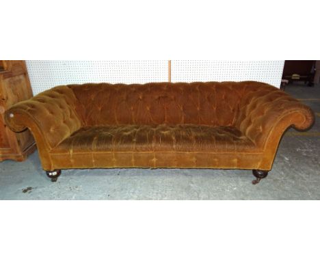 A Victorian button upholstered Chesterfield sofa on turned mahogany supports, 232cm wide.   E8