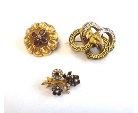 A garnet set shaped circular brooch, mounted with four oval cut garnets, the back glazed with a locket compartment, a Victori