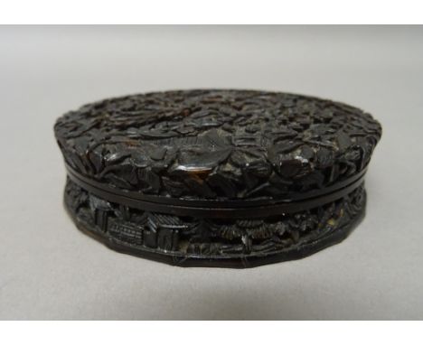 A Chinese export tortoiseshell circular snuff box and cover, mid 19th century, finely carved with figures, pavilions and tree
