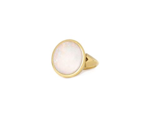 An 18ct gold and opal single stone ring, collet set with an oval opal, otherwise with a textured finish, ring size J and a ha