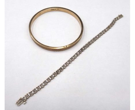 A 9ct gold and diamond set bracelet, claw set with a row of circular cut diamonds, on a snap clasp, length 19cm and a 9ct gol
