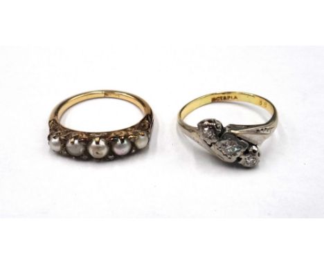 A gold and platinum, diamond set three stone ring, mounted with a row of circular cut diamonds in a crossover design, detaile