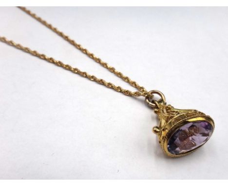 A 9ct gold and amethyst set single stone pendant fob, having ropetwist and wirework decoration, with a 9ct gold ropetwist lin