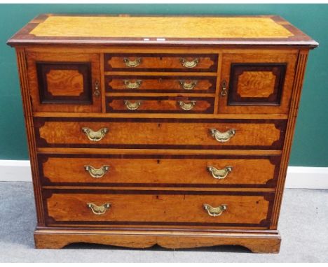 A Victorian rosewood banded figured ash chest, with three short drawers flanked by cupboards, over three further long graduat