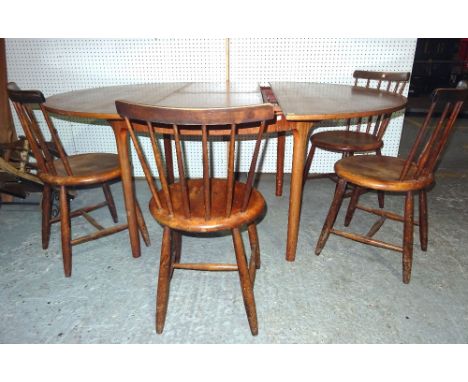 A.H Macintosh; a 20th century teak circular extending dining table with one integral leaf, 124cm wide x 75cm high, 160cm full