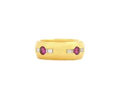 An 18ct gold, ruby and diamond ring, mounted with four circular cut rubies and with a baguette diamond, mounted at the side o