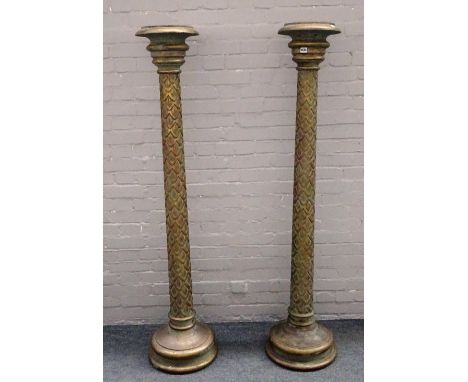 A pair of 18th century style parcel gilt green painted torcheres with scale carved column and stepped circular bases, 173cm h