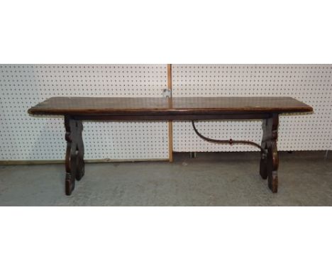 An early 20th century Spanish oak rectangular bench on trestle supports, lacking one metal bracket, 135cm wide x 47cm high.  