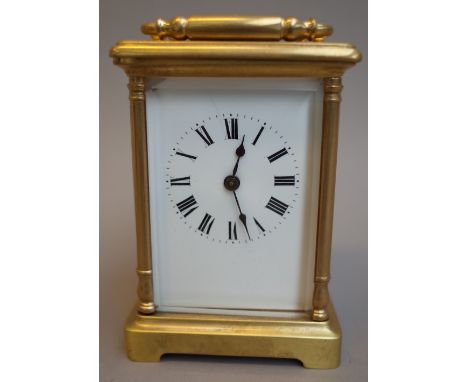 A brass cased carriage clock, 20th century, with visible escapement, white enamel dial and a single train movement, 11.5cm hi