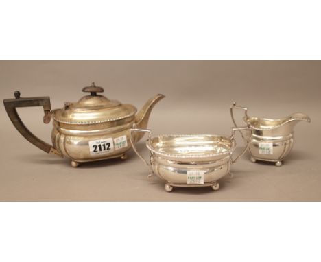 A silver composite three piece tea set, comprising; a teapot, a twin handled sugar bowl and a milk jug, each piece decorated 