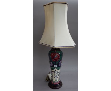 A Moorcroft style pottery table lamp of foliate Arts & Crafts design on a wooden plinth with shaped shade, 38cm high excludin