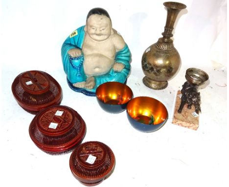 A group of Asian works of art, comprising; a biscuit and turquoise glazed seated Buddha; a silver metal elephant converted to