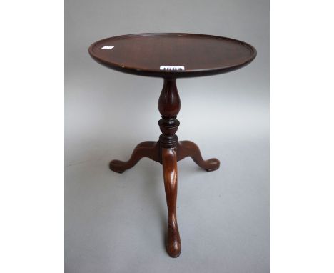 A diminutive mahogany tripod table with circular dish top and baluster column, 28cm diameter x 34cm high.