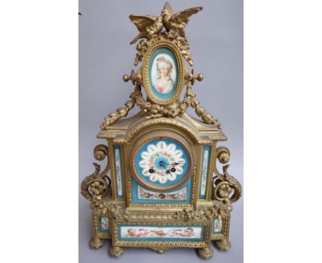 A French porcelain mounted gilt metal eight-day mantel clock, early 20th century, with bird surmount over an oval porcelain m