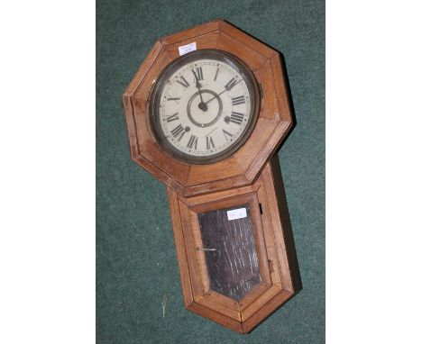 20th Century wall clock, the dial with Roman numerals, housed in an octagonal case with glazed door to the lower section, 57.