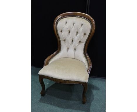 Victorian style nursing chair, the spoon form back with button upholstery, serpentine front seat, on cabriole legs