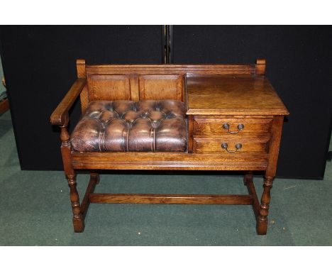 Oak telephone table with two drawers and brown leather effect button seat, raised on turned legs and flattened stretchers