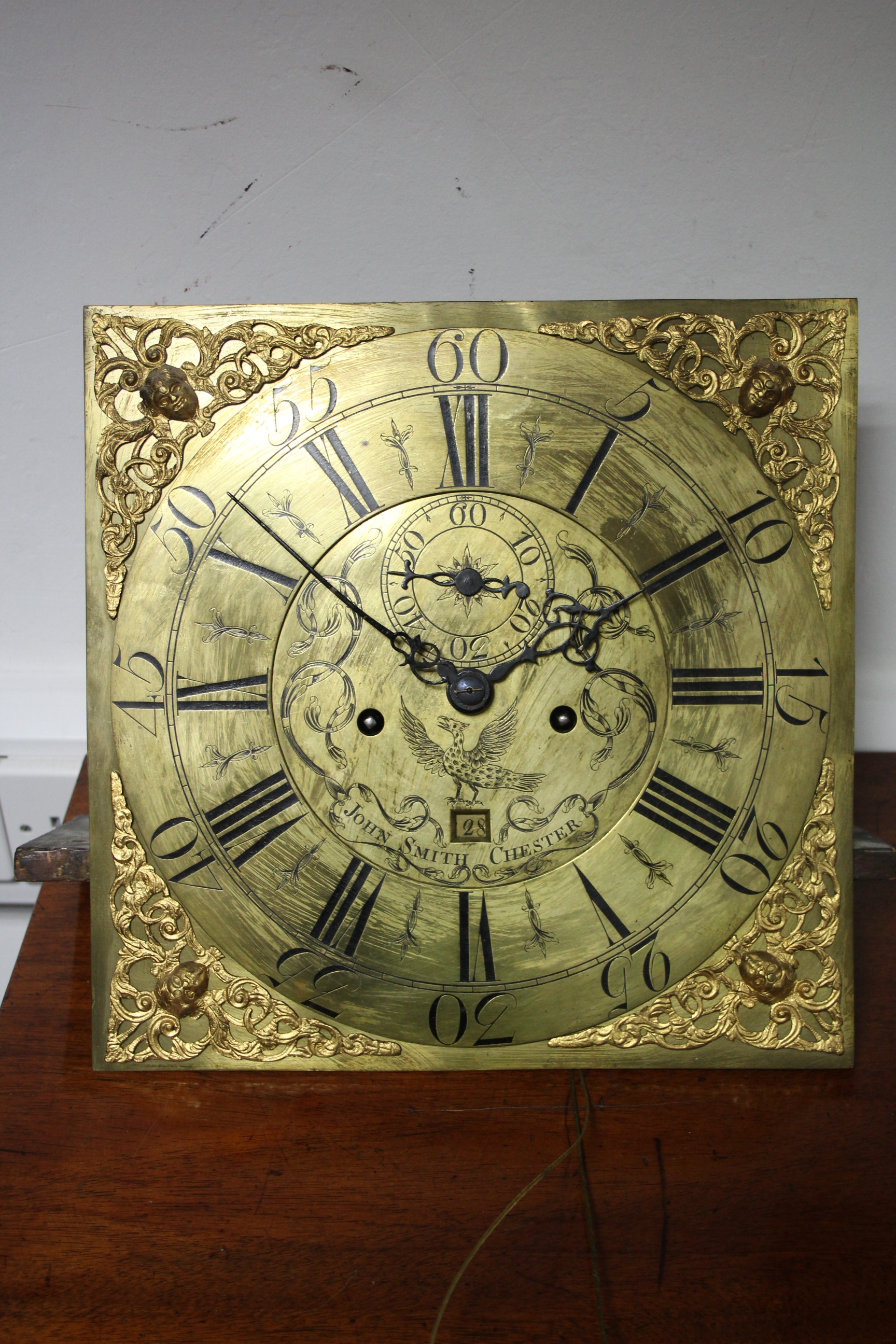 AN 18th century LONGCASE CLOCK, the 12" brass dial signed "John Smith