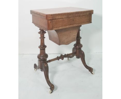 Victorian walnut games/work table, the rectangular swivel top with rounded front corners, opening to reveal backgammon and ch