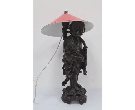 Chinese carved hardwood figure of man with rui sceptre as a table lamp, the figure standing on a rockwork base, 65cm high ove