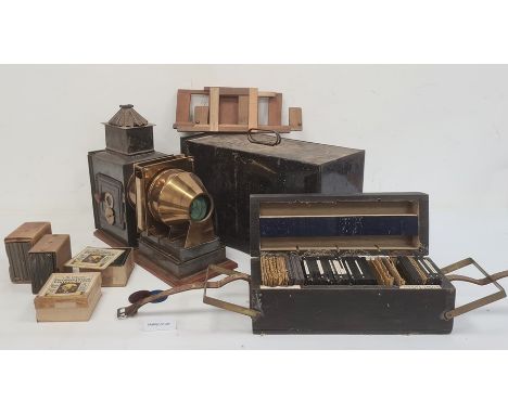 Antique brass black japanned metal magic lantern in metal carrying case and large quantity of boxed magic lantern slides