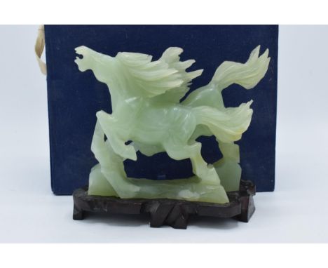 A boxed Chinese Jade (or similar) carved figure of a pair of horses on wooden plinth. 20cm long. In good condition with no ob