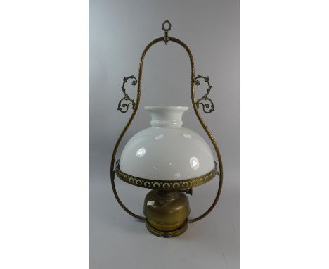 A Late 19th Century Brass Oil Lamp in Wall Hanging Frame with Opaque White Glass Shade, 62cm High 