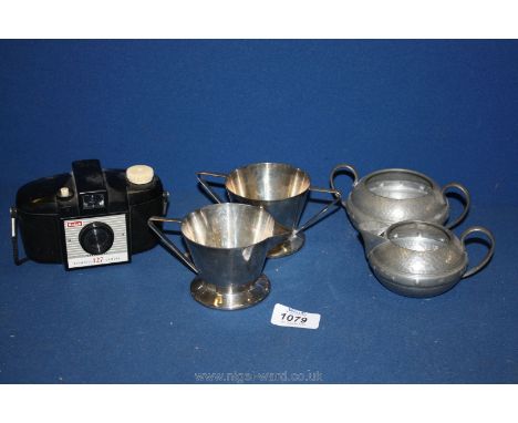 A Kodak Brownie 127 Camera, an English pewter milk Jug and sugar basin and Manco electro plate Art Deco milk Jug and sugar ba