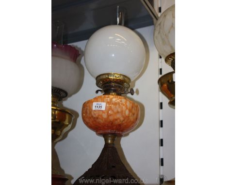 An orange glass Oil Lamp and shade