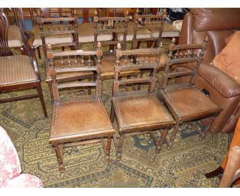 A set of six Oak framed dining Chairs, having bobbin turned details to the backs, turned front legs, H stretchers and embosse