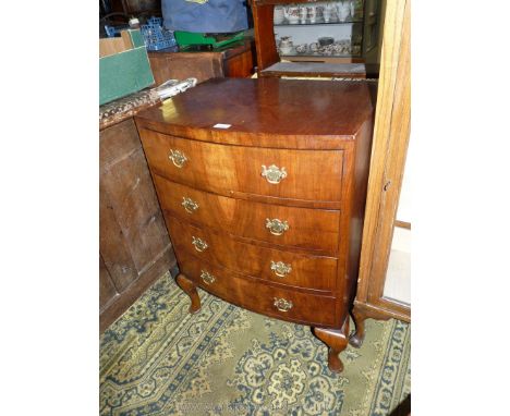 A bow fronted, probably 1930's Chest of four short drawers having brass drop handles standing on brief cabriole legs, 24'' wi