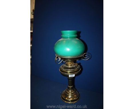 A Brass Oil Lamp with green glass shade