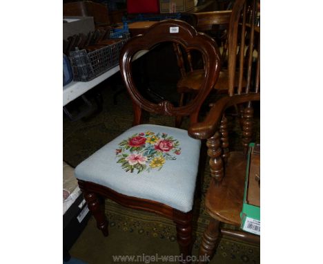 A 19th century side Chair, having balloon style back, turned front legs and over-stuffed seat with tapestry depicting stylize