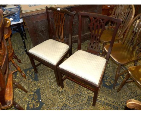 Two older reproduction with Mahogany Chippendale style dining Chairs, having fret worked splats and drop-in seats.