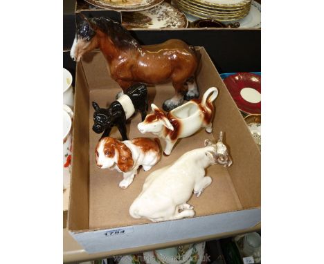 A Wien bull lying down, a Goebel cow creamer, a spaniel, a Staffordshire Shire horse and a black and white calf.