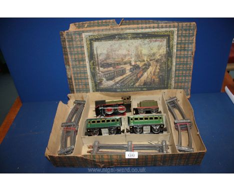 A Marklin (Germany) complete clockwork Train set with locomotive coaches, track and key in original box. In excellent working
