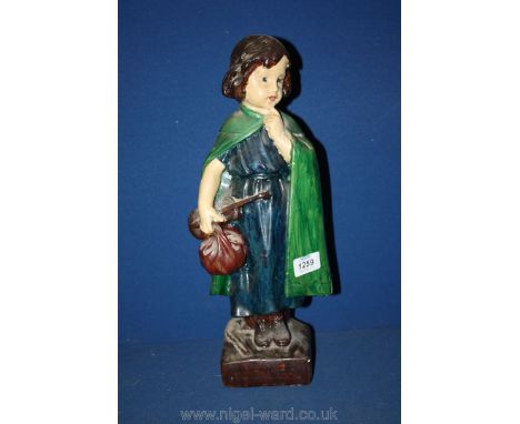A plaster figure of a girl in a green cloak with a carry bag and violin, inscribed "I Wonder", 16" tall.