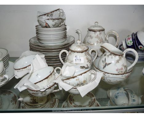 A Japanese eggshell Teaset including teapot, jug, sugar bowl, eight cups and saucers, ten tea plates and a slop bowl