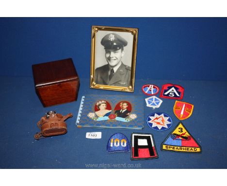 A picture framed Vietnam war veteran with eight military arm patches, a Coronation Autograph Book with tin plate boards by Ri