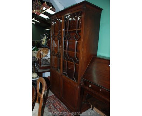 A c1900/later 19th c. Cabinet on Cupboard, the upper section with a pair of opposing seventeen pane glazed doors revealing li