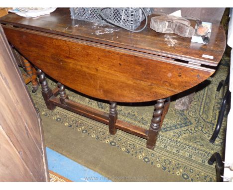 A heavy Oak 1930's dropleaf gateleg Dining Table having twist legs, the top 47 3/4'' x 17 1/2'' extending to an oval 44'' app