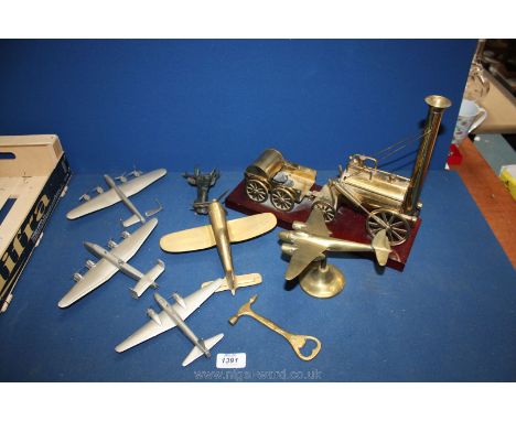 A brass model of Stephenson's rocket on a wooden plinth, a cast stag's head, a pewter model of Wellington III aeroplane, with