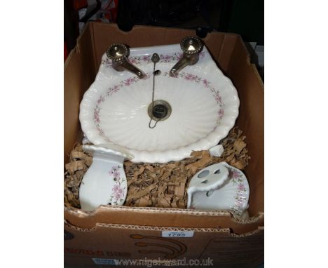A floral bedroomware Basin (for wall mounting) and accessories by Porcelain De Paris, marketed by Harrods. 