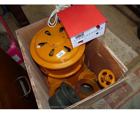 A packing case containing a 1kw Hydro Generator and control gear circuit box, etc., (A small-scale Hydro-electric turbine).